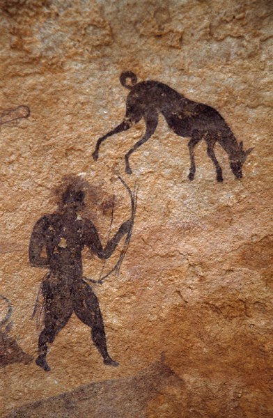 Djanet, Algeria. Showing a man with bow and a dog from the pastoral period of Saharan art. Image ID: algdja0090020