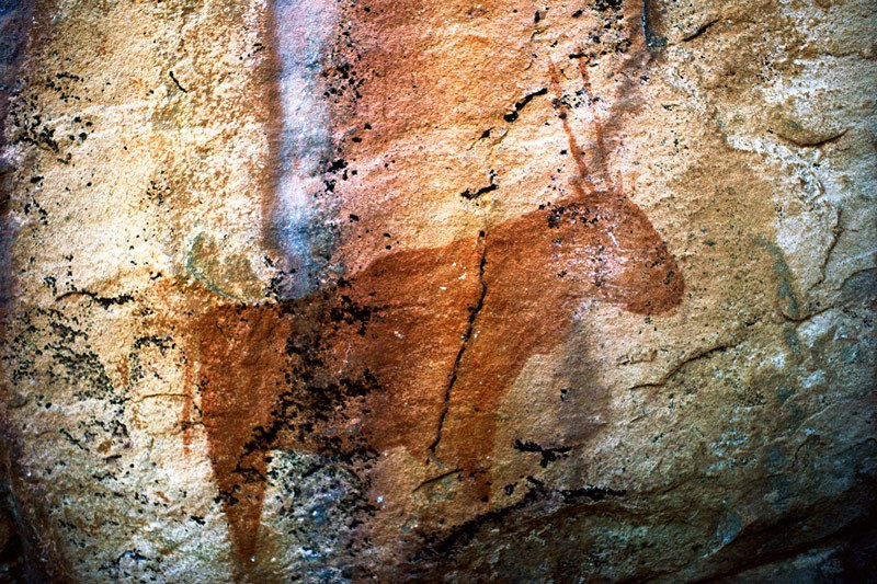 Tsodilo Hills. Red silhouette antelope (gemsbok) facing right. Image ID: bottsd0820001