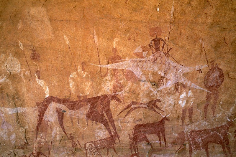 Ennedi plateau. ‘Flying’ camel with mounted warrior, row of warriors holding spears and shields, bichrome cow with collar and bichrome cattle. Image ID: chaenp0050026