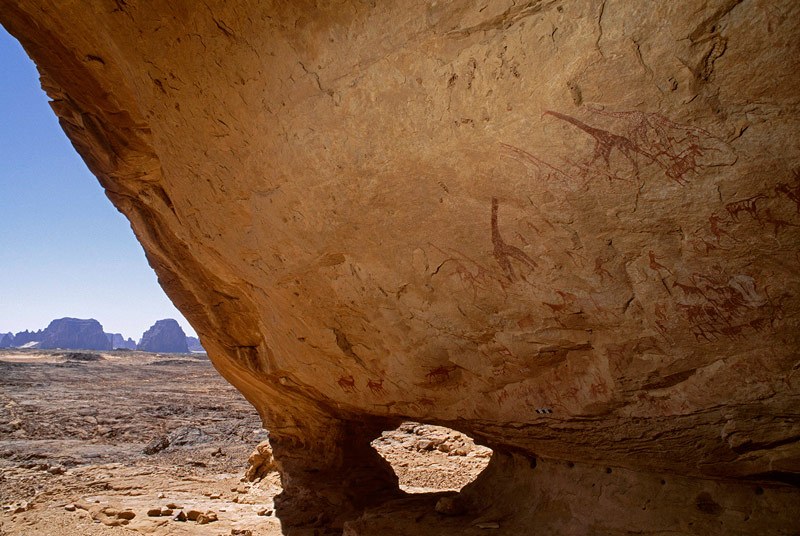 Tassili d' Emi Koussi. Looking out from the entrance of a large sandstone cave on the lower slopes of Emi-Koussi. The cave is high and about 18 metres wide at the  mouth. Image ID: chatek0070001
