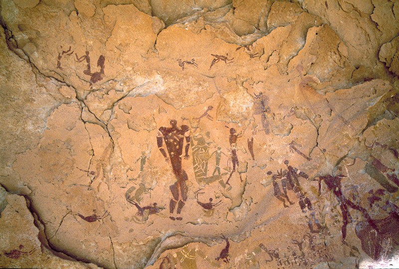 Wadi Sura. Top from left, two maroon kneeling men with hands raised facing each other.Maroon mythical animal with elongated neck and long ears. Faded row of bichrome men with headdresses/animal heads. Image ID: egywsu0010005