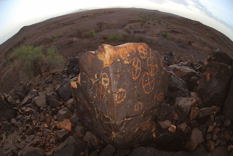 Lokori. 'Fish-eye' photograph of boulder showing engravings on two sides of boulder. Image ID: kenlok0010056