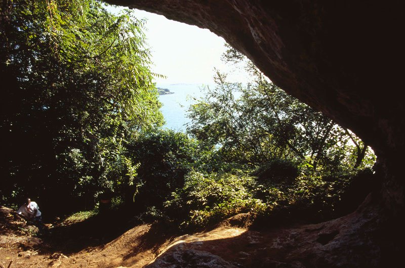 Lake Victoria. Looking out of Mawanga Cavern and across Lake Victoria. Geometric designs are painted on the right-hand wall of the cavern when facing outwards. Suba. Image ID: kenvic0020001