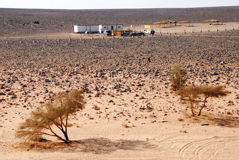 Messak. Ugly storage containers next to tourist car park at the Wadi Mathendous site. Image ID: libmes0170004