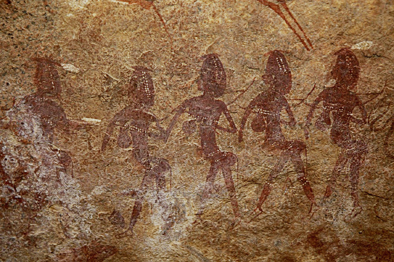 Initiation Shelter- a line of bejewelled girls walk left probably to an initiation