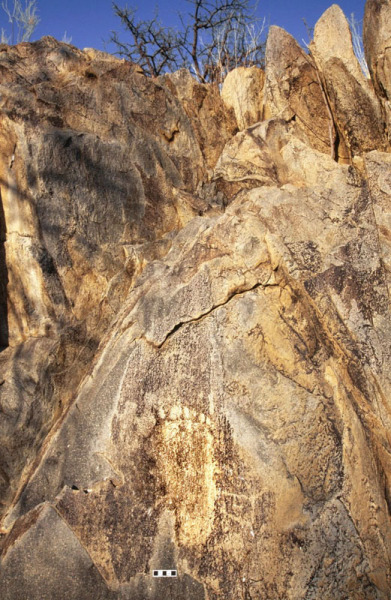 A six toed footprint engraved onto the rock, facing upward