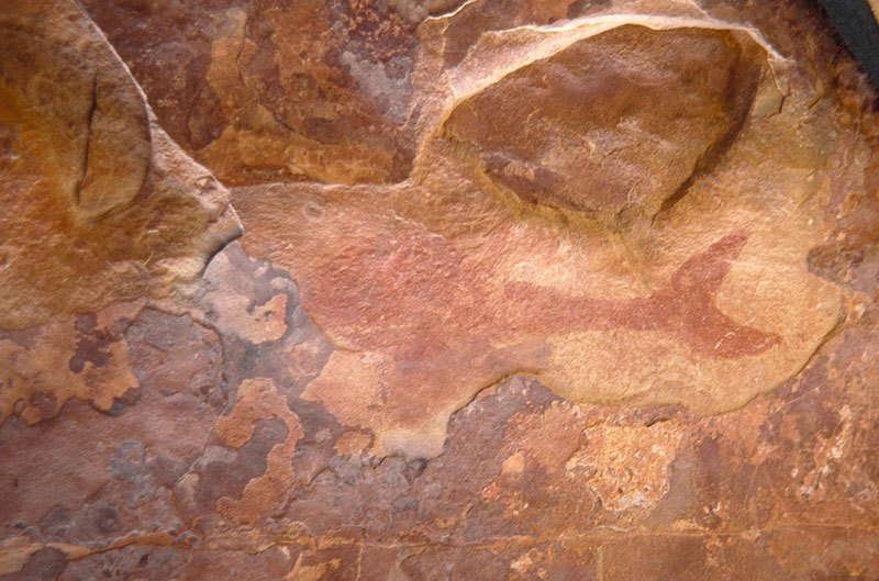 Aar Farm, Namibia. Red solid painting of fish/whale facing left. Image ID: namsna0020004
