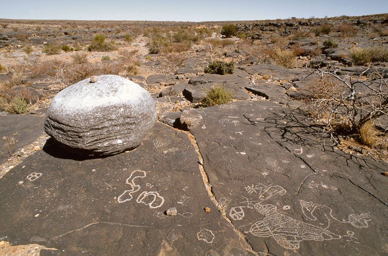 Aar Farm, Namibia. Enlarged view of a boulder on slab. Highly complicated engraving at bottom right involves geometric design with areas in-filled with light pecking, circle with cross in-filled with light pecking and joined by snaky line half circle in-filled with light pecking. Image ID: namsna0040011