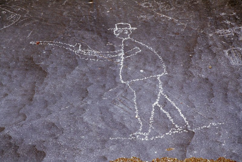 Huns Mts, Namibia. Man firing gun. Image ID: namsnh0030008