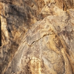 A six toed footprint engraved onto the rock, facing upward