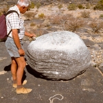 Aar Farm, Namibia. Free-standing boulder, well rubbed on upper surface that also has cupules. When struck, rock chimes. Right next to boulder, geometric design and concentric circles, and foreground, recent curvilinear engravings. Note apparently natural grooves around two sides of boulder. Image ID: namsna0040005