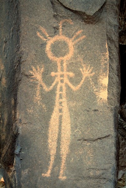 Air Mountain, Niger. Man with necklace, tight fitting clothes and possible sticks in hands. “Bash’ marks on side of rock suggest rock gong. Horse Period. Image ID: nigeam0010070