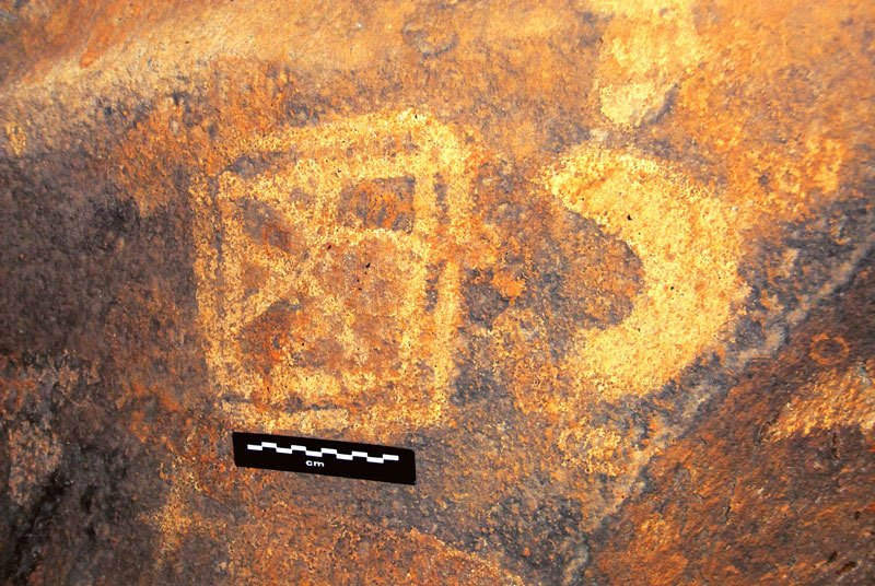 Dhayamole. Details from SOMDouble square containing web (striding figure?) and crescent outlined in black. Image ID: somdha0020042