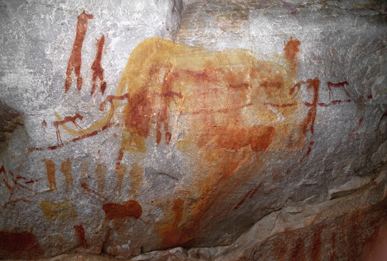 Yellow painting of a large elephant overlays red paintings of animals and human figures. In the middle ground several animals are depicted on a rope or string, SOASWC0060002