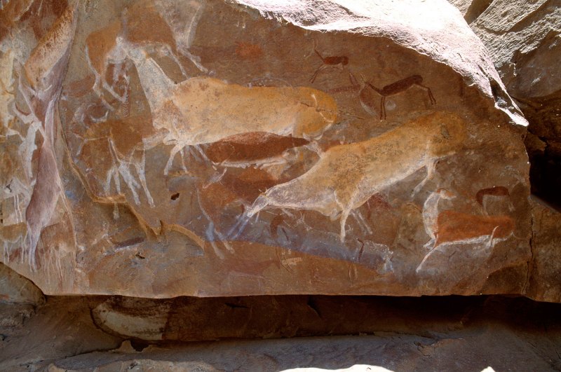 Drakensberg, South Africa. Man at lower centre wearing kaross (skin cloak), young buck with white leg prancing to left, and two human (?). Image ID: soadrb0040025