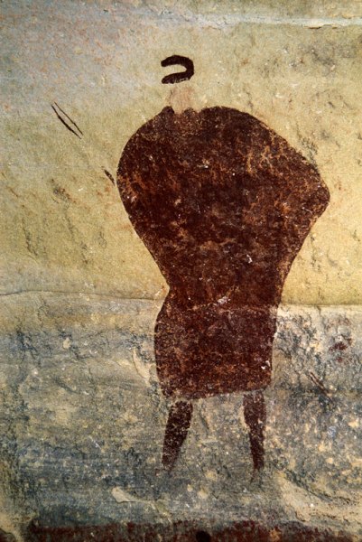 Drakensberg, South Africa. Man, painted in dark red wearing fringed kaross and holding bow, faces forward. Image ID: soadrb0080047