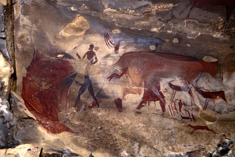 Drakensberg, South Africa. Numerous superimpositions, particularly huge kaross-clad figure between elongated man facing left and rear of mythical animal. Note above flank of mythical animal the animal’s head facing right of person with a mane of hairs on the neck. Image ID: soadrb0090005