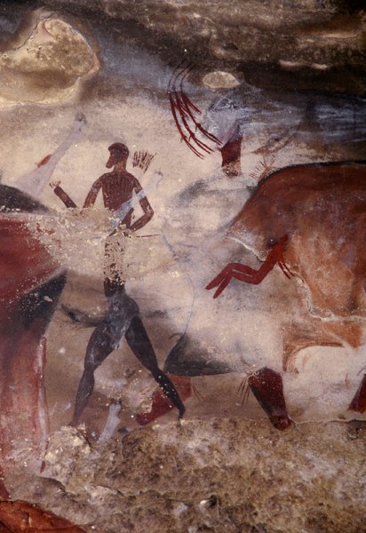 Drakensberg, South Africa. Numerous superimpositions, particularly huge kaross-clad figure between elongated man facing left and rear of mythical animal. Note above flank of mythical animal the animal’s head facing right of person with a mane of hairs on the neck. Image ID: soadrb0090008