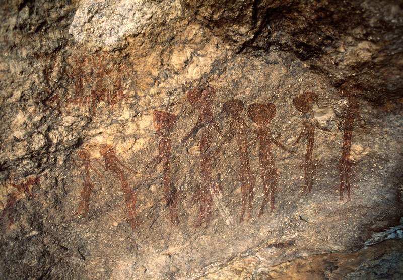 Four people seated and line of nine people standing/dancing. Image ID: tankon0100004
