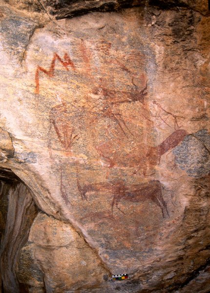 Top, parallel wavy lines surmounted by wavy line of dots, solid red arm and schematic head suggest person ‘floating’ to left towards red ‘lightning’ design held by solid red figure at right. Lower, kudu bull, antelope faced by two men with one of them holding bow. Lower, running kudu bull. Image ID: tankon0130008