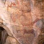 Top, parallel wavy lines surmounted by wavy line of dots, solid red arm and schematic head suggest person ‘floating’ to left towards red ‘lightning’ design held by solid red figure at right. Lower, kudu bull, antelope faced by two men with one of them holding bow. Lower, running kudu bull. Image ID: tankon0130008