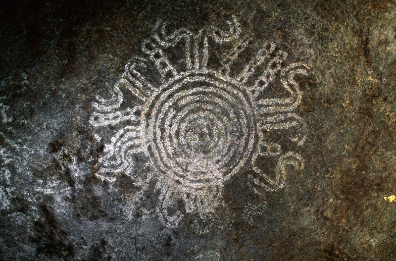 Teso, Uganda. Red geometric paintings on a granite face at the entrance to a well-protected rock shelter. Image ID: ugates0030003