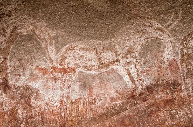 Mashonaland, Zimbabwe. Large elephant. From middle left, superimpositions include running and falling men, two holding bows; antbear/aardvark tied with two strings; zebras facing left and right; striped zebra facing right; giraffe; two sets of decorated elongated ovals. Image ID: zimmsl0240010