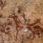 Mashonaland, Zimbabwe. Red recumbent figures amongst numerous skin bags, quivers with arrows, bow hunting bags and other equipment. Image ID: zimmsl0230043